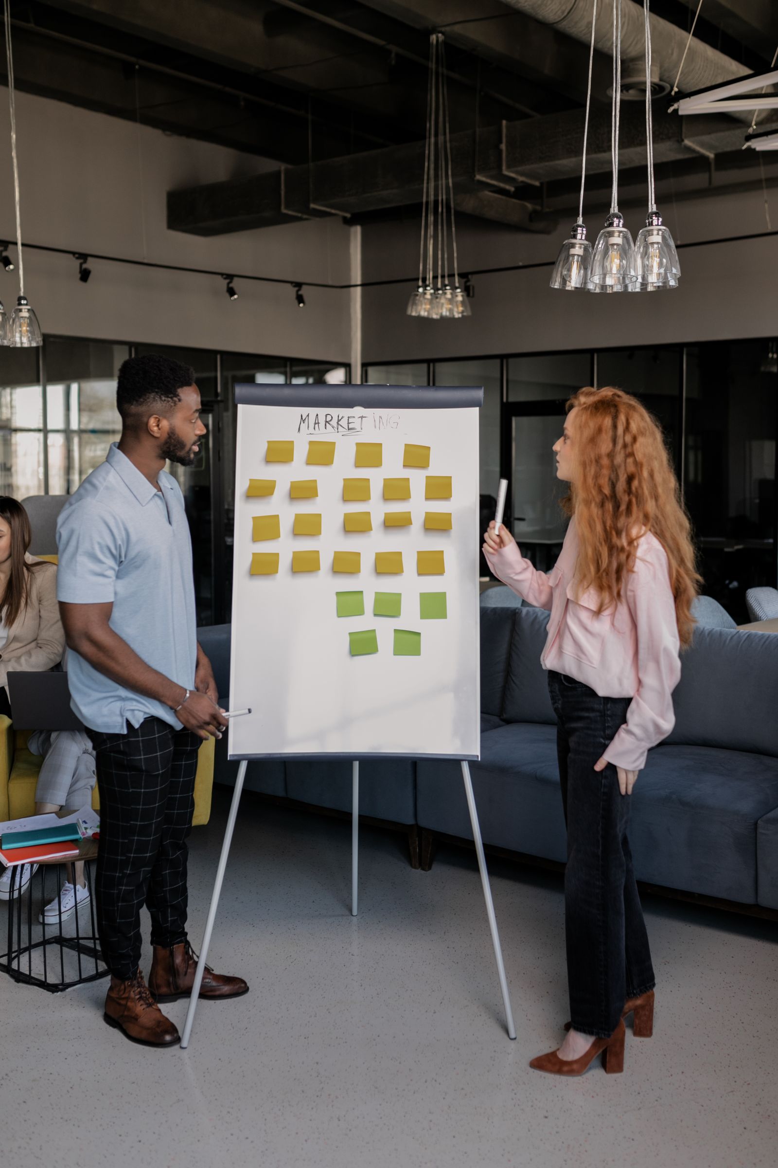 Colleagues planning a marketing strategy with sticky notes