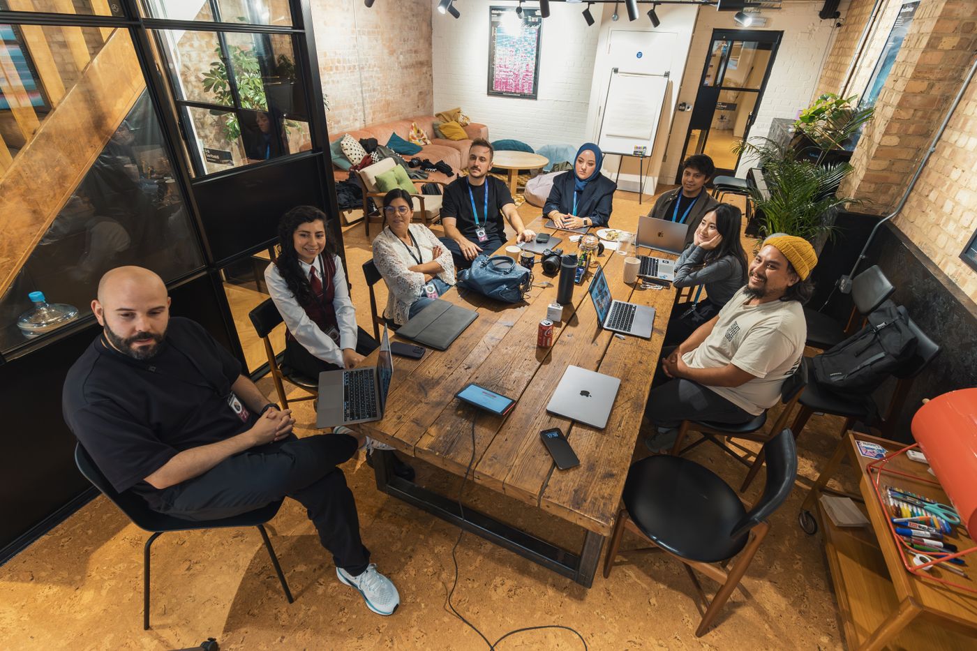 Diverse team collaborating with laptops in a modern workspace